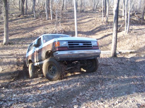 1989 Ford Bronco - This 1989 Ford Bronco tackles a challenging off-road trail in a wooded area.