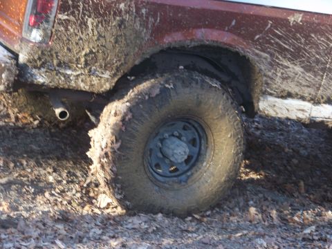 1989 Ford Bronco - Muddy 1989 Ford Bronco rear tire and fender during off-road excursion.