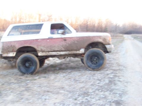 1989 Ford Bronco - This 1989 Ford Bronco is navigating a muddy dirt road.