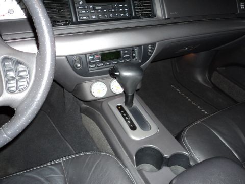 2004 Mercury Grand Marquis - Interior view of a car's center console and dashboard, showing the gear shifter and gauges.