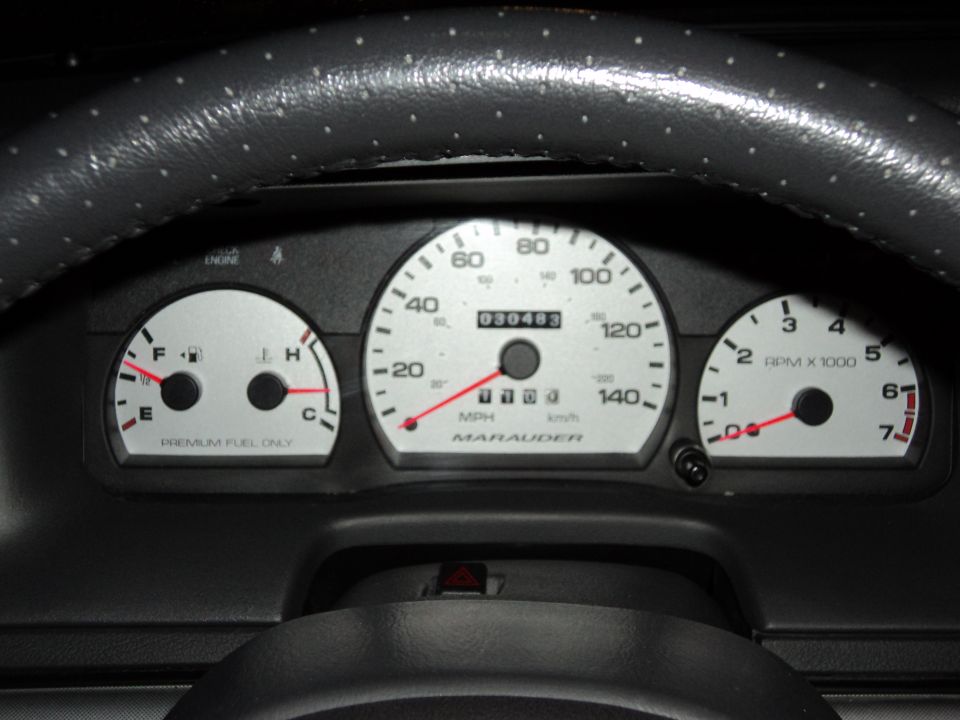 Instrument cluster showing speedometer, fuel/temp gauge, and tachometer, odometer at 030483.
