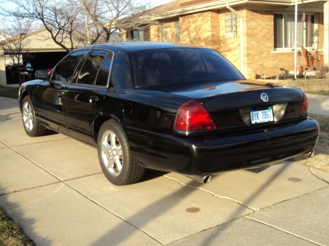 2004 Mercury Grand Marquis - Rear 3/4 view of a black 2004 Mercury Grand Marquis parked on a driveway.