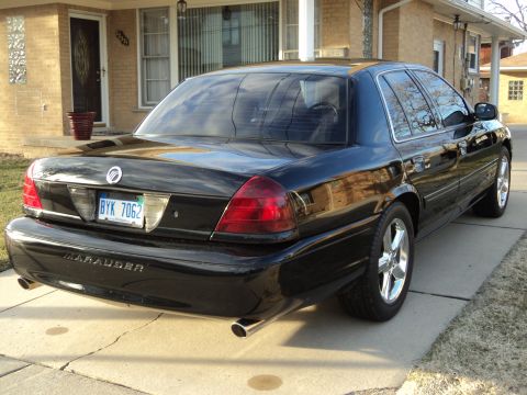 2004 Mercury Grand Marquis - The rear view of a black Mercury Marauder shows its distinctive taillights and dual exhaust pipes.