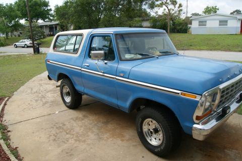 1978 Ford Bronco - This 1978 Ford Bronco is parked on a concrete driveway with a house and trees in the background.