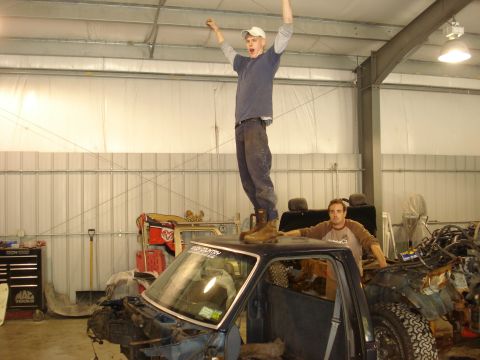 1993 Ford F-150 - Two men celebrate inside a garage with a disassembled truck.