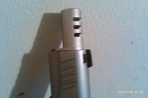 2000 Mercury Grand Marquis - A close-up view of a silver gun barrel with distinctive venting and slide markings.