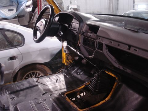 1993 Ford F-150 - The interior of a 1993 Ford F-150 is shown during a restoration project, with parts removed and a second vehicle visible.