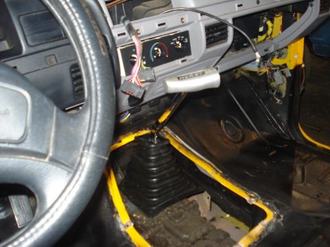 1993 Ford F-150 - Interior of a 1993 Ford F-150 showing the dashboard, steering wheel, and a Hurst shifter, with visible yellow trim.