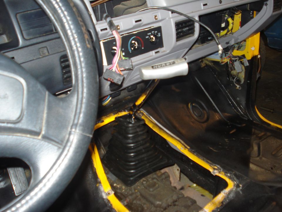 Interior view of a 1993 Ford F-150 with a Hurst shifter and yellow trim