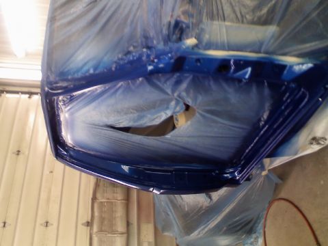 1993 Ford F-150 - A car door is being prepped and painted, covered in blue plastic sheeting.