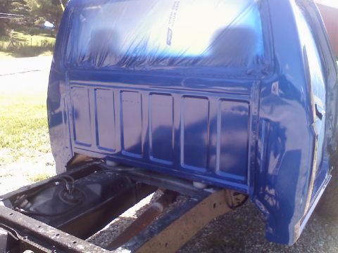 1993 Ford F-150 - Pickup truck bed being prepped for paint, showing the frame and fuel tank underneath.