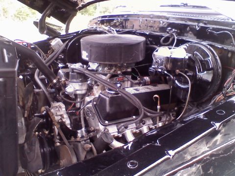 1993 Ford F-150 - The engine bay of a vehicle is shown, a V8 engine with an aftermarket air cleaner and visible brake components.