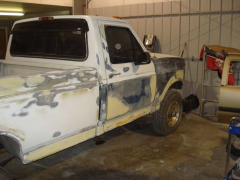 1993 Ford F-150 - This 1993 Ford F-150 pickup truck is shown in a workshop with extensive body filler applied to its exterior panels.