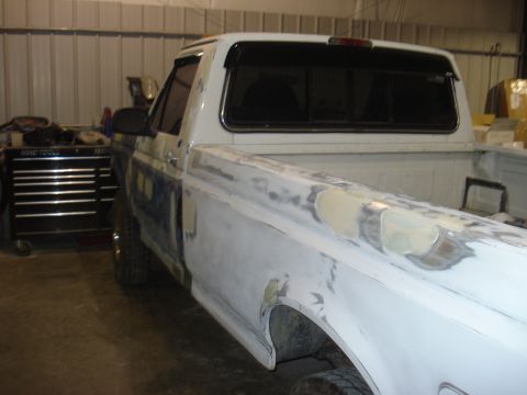 1993 Ford F-150 - Passenger side view of a 1993 Ford F-150 undergoing body repair with filler applied.