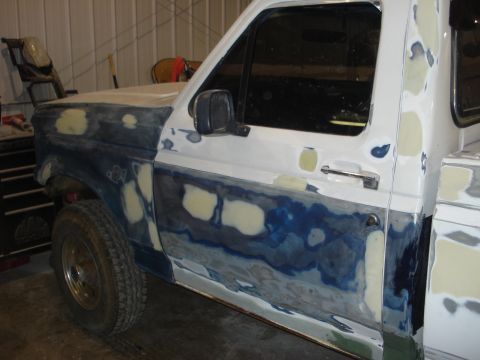 1993 Ford F-150 - This truck is undergoing body repairs, with primer and filler visible on the fender and door panels.