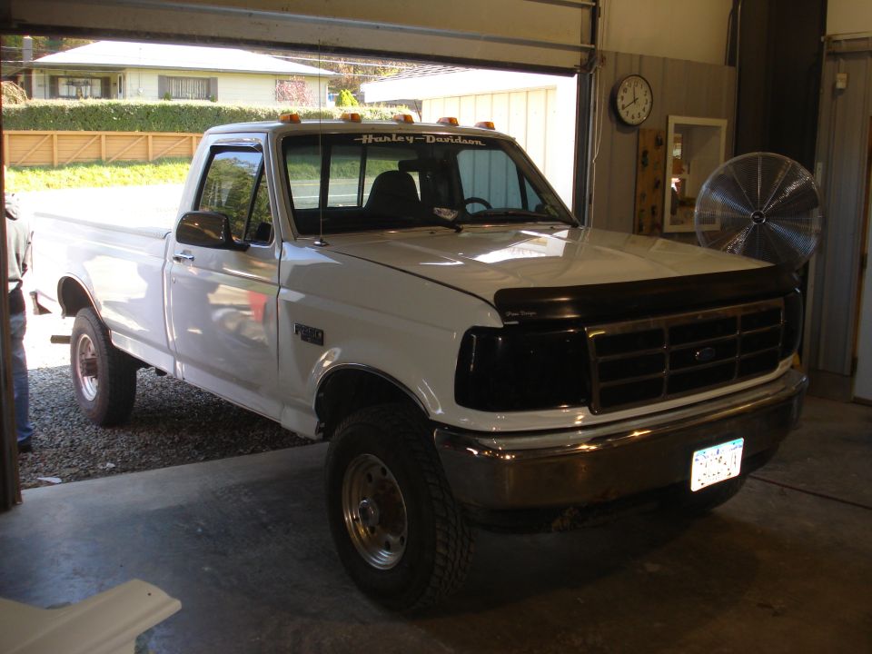 White 1993 Ford F-150 truck, 3q-front view. Harley-Davidson decal on windshield