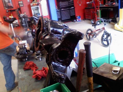 1993 Ford F-150 - Workbench with disassembled automotive drivetrain components and tools in a garage setting.