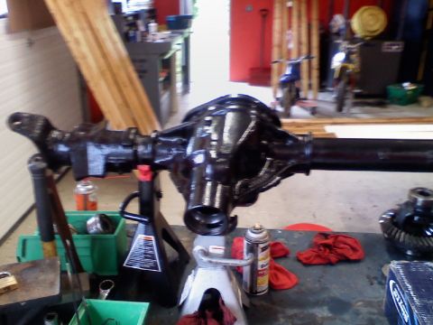 1993 Ford F-150 - A vehicle's differential assembly is shown on jack stands in a workshop setting.
