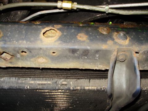 1995 Ford Bronco - The vehicle's frame shows significant rust and corrosion, with holes visible in the metal.