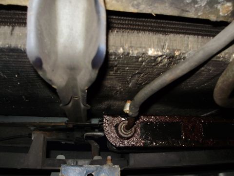 1995 Ford Bronco - Close-up view of a vehicle's radiator and hoses, showing signs of wear and fluid leaks.