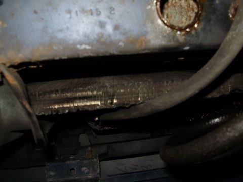 1995 Ford Bronco - Close-up view of the radiator and hoses of a 1995 Ford Bronco, indicating the vehicle's model year.