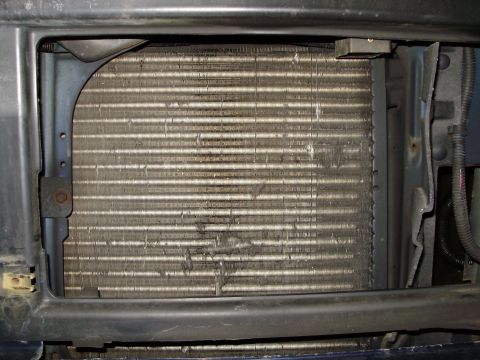 1995 Ford Bronco - The radiator fins are bent and dirty, indicating potential damage or wear.