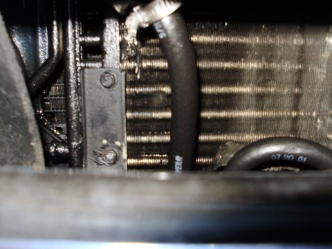 1995 Ford Bronco - Close-up view of a vehicle's radiator and hoses, with a date stamp visible on one of the hoses.