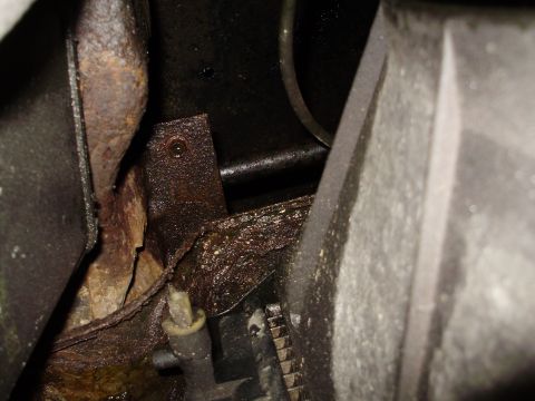 1995 Ford Bronco - Close-up view of heavily rusted frame and engine components, suggesting significant wear or age.