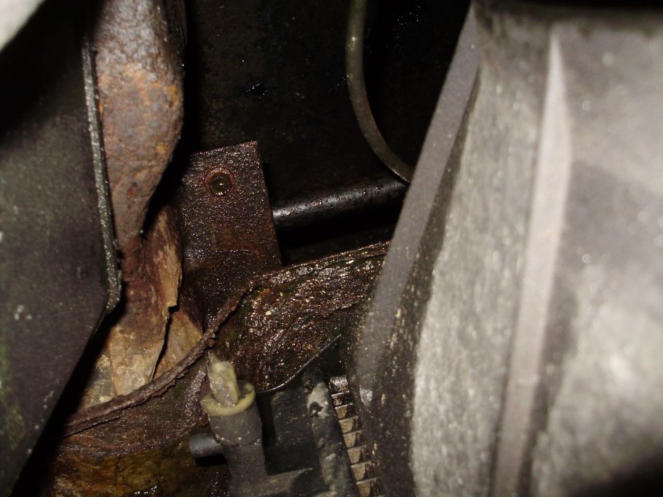 Rusted frame and engine components, close-up view