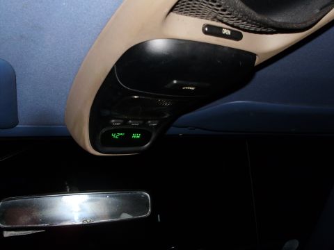 1995 Ford Bronco - Interior view of a vehicle's overhead console showing temperature and compass readings.