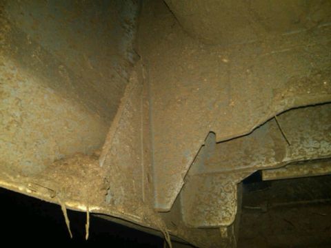 1995 Ford F-150 - Underside view of heavily rusted vehicle frame and suspension parts.