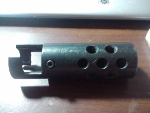 1989 Ford Bronco - This black muzzle brake features six circular holes and a mounting bracket.