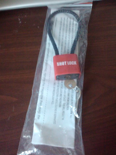 1989 Ford Bronco - A red cable lock labeled 'SHOT LOCK' is shown in its original packaging with a key and instructions.