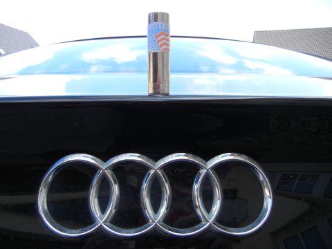2010 Audi A4 - Close-up of the Audi emblem on a black car, with a 'Voted' sticker visible above it.