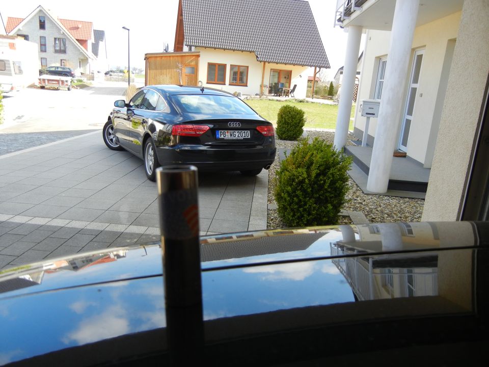 Black Audi A5 coupe parked in driveway, license plate PB WG 2010