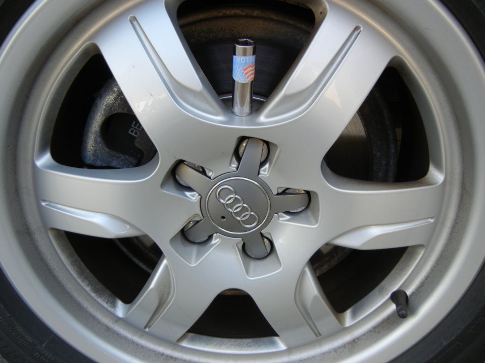 Silver Audi wheel with patriotic valve stem cap