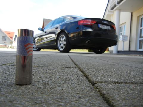 2010 Audi A4 - Socket wrench in front of a black Audi sedan, parked on a paved driveway.