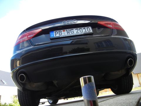 2010 Audi A4 - The rear of a black Audi sedan is shown, dual exhaust pipes and a license plate.