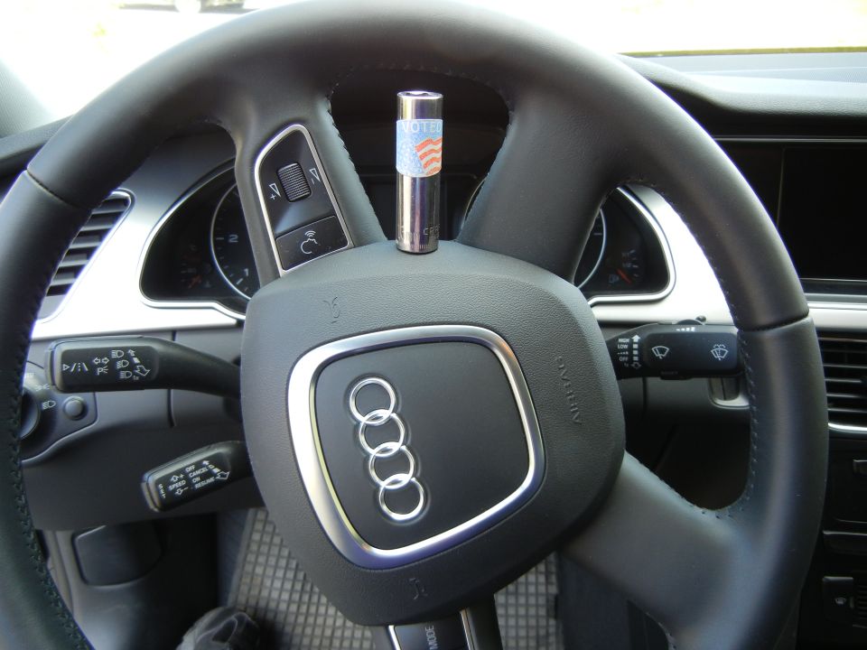 2010 Audi A4 steering wheel with a small cylindrical object on the airbag cover