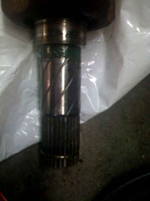 1995 Ford Probe - This image shows a splined shaft, likely a vehicle component, with signs of wear and lubrication.