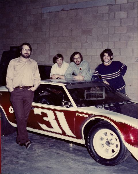 1973 Ford Mustang - A 1973 Ford Mustang race car, numbered 31 and Firestone tires, is shown with four men posing beside it.