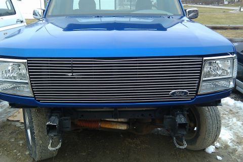1993 Ford F-150 - Front view of a blue 1992 Ford F-150 showing its chrome grille and tow hooks.