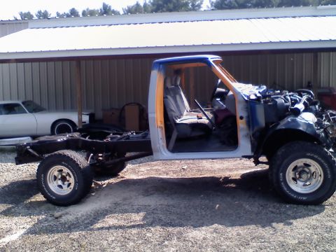 1993 Ford F-150 - This truck is missing its engine and body panels, sitting on its chassis with the cab exposed.