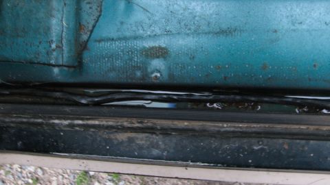 1992 Ford Bronco - Water has collected in the door seal of this 1992 Ford Bronco, indicating potential rust and tear-down issues.