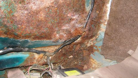 1992 Ford Bronco - Severe rust damage visible on the interior floor pan, with wiring harnesses exposed.