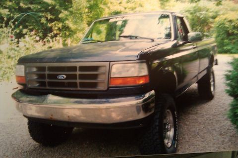 1993 Ford F-150 - This Ford truck features a chrome bumper and a prominent grille with the Ford logo.