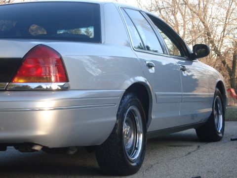 2000 Ford Crown Victoria - Rear view of a silver 2000 Ford Crown Victoria sedan with chrome accents.