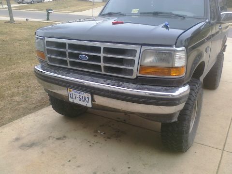 1995 Ford Bronco - This 1995 Ford Bronco features a lifted suspension and a prominent grille.