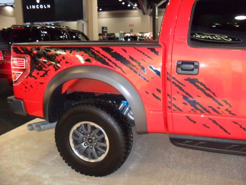 2011 Ford F-150 - This red pickup truck features aggressive black graphics that resemble claw marks on its body panels.