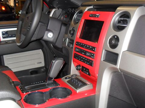 2011 Ford F-150 - The interior of a 2011 Ford F-150 features a striking red trim accenting the center console and dashboard.